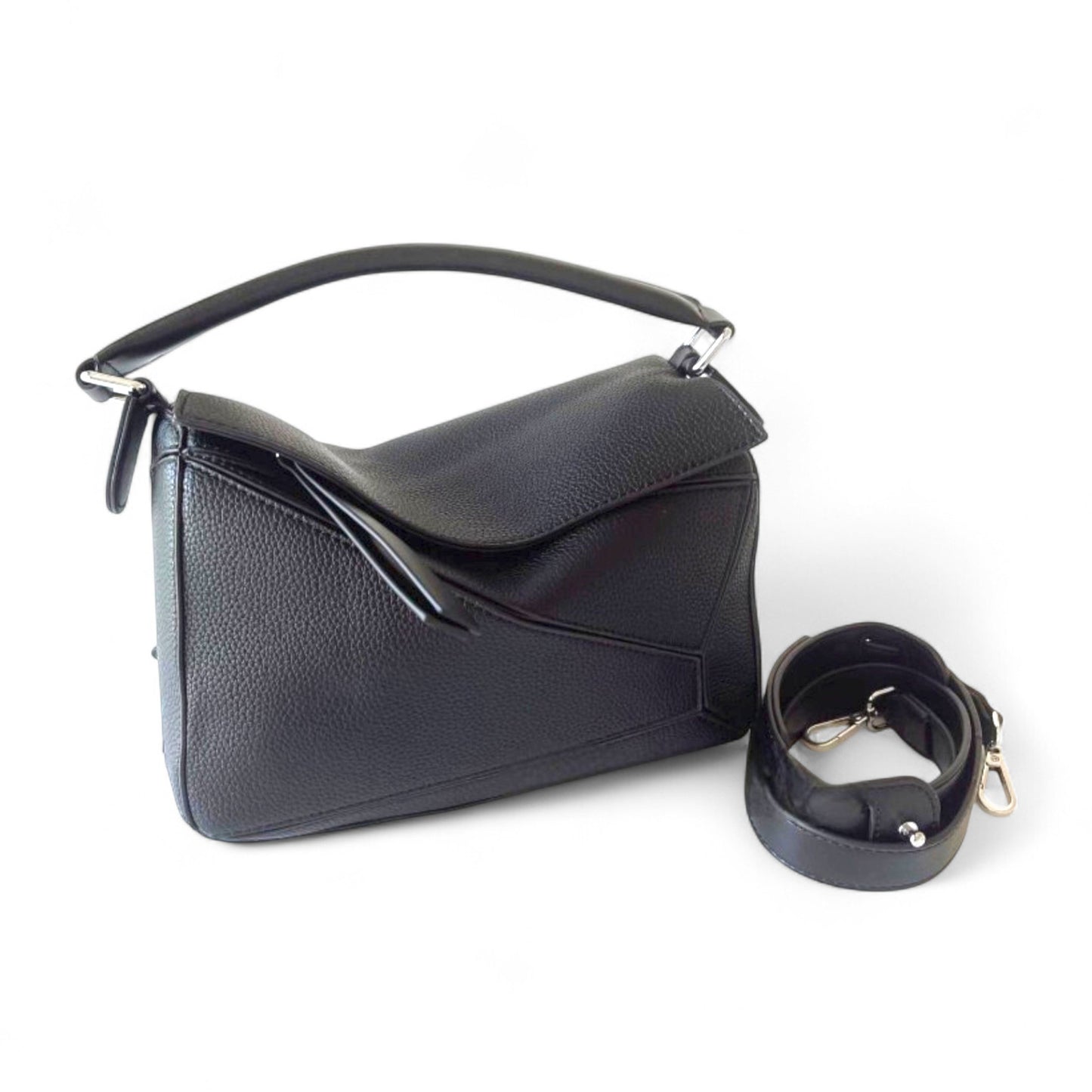 A black handbag with geometric panels, top handle, and adjustable crossbody strap is shown beside the bag.