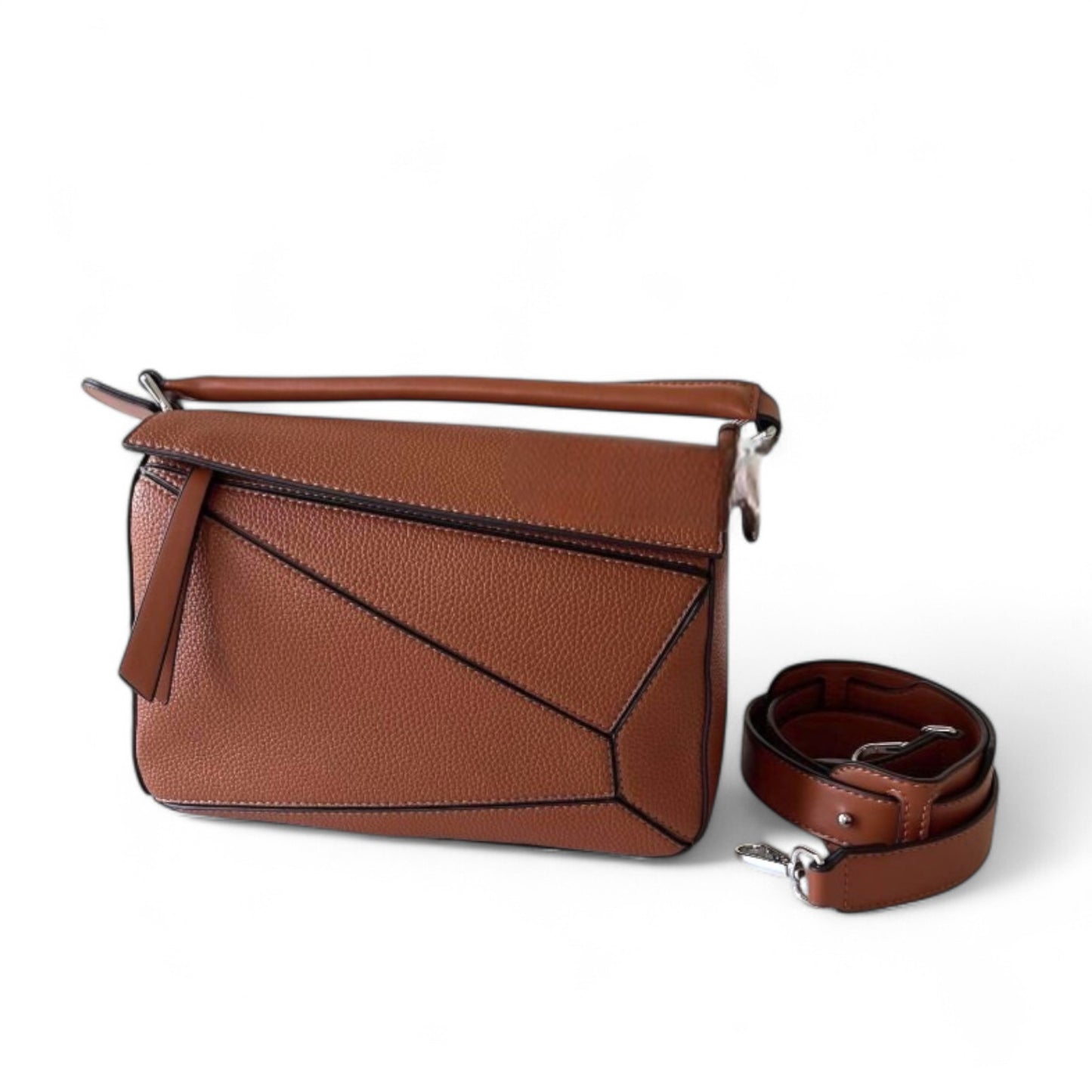 A brown handbag with geometric panels, top handle, and adjustable crossbody strap is shown beside the bag.