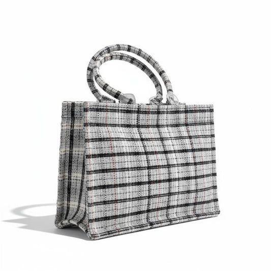 Angle view of a classic black and white tweed book tote.