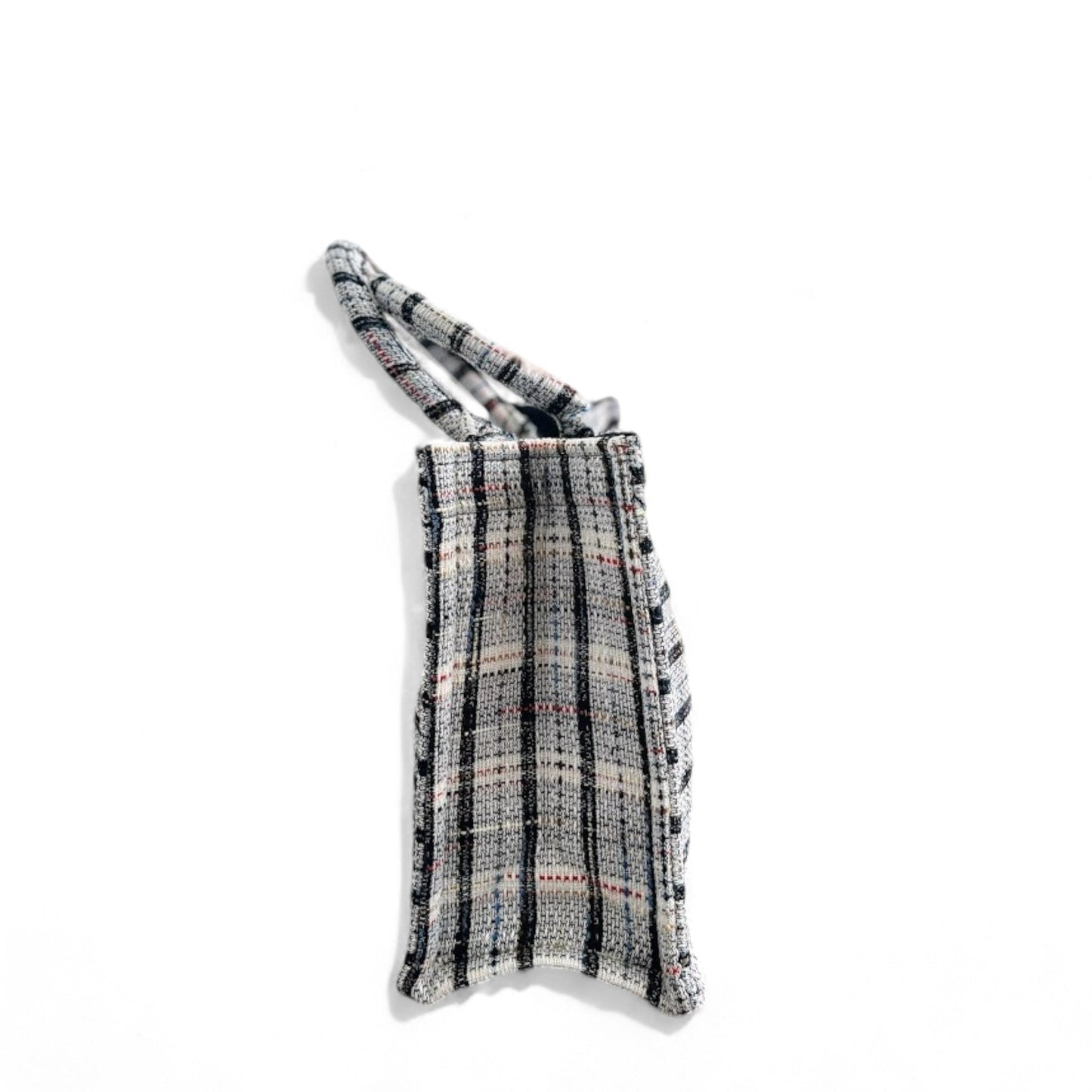 A Classic plaid-patterned white tweed book tote in side view.