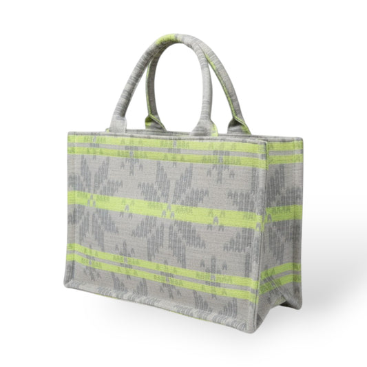 Angle view of a sturdy tote bag with neon green stripes on light grey jacquard fabric.