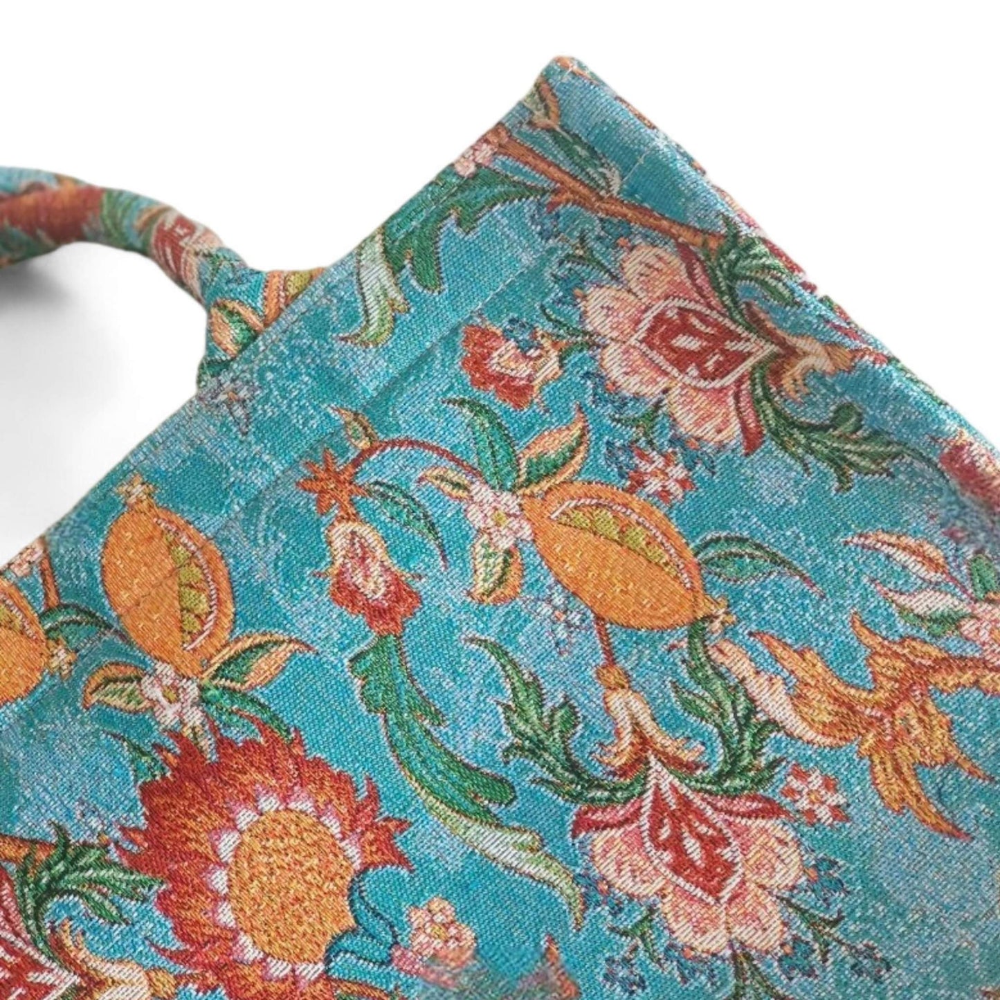 A vintage blue floral tote bag, highlighting the intricate jacquard fabric and pattern - Close-up.