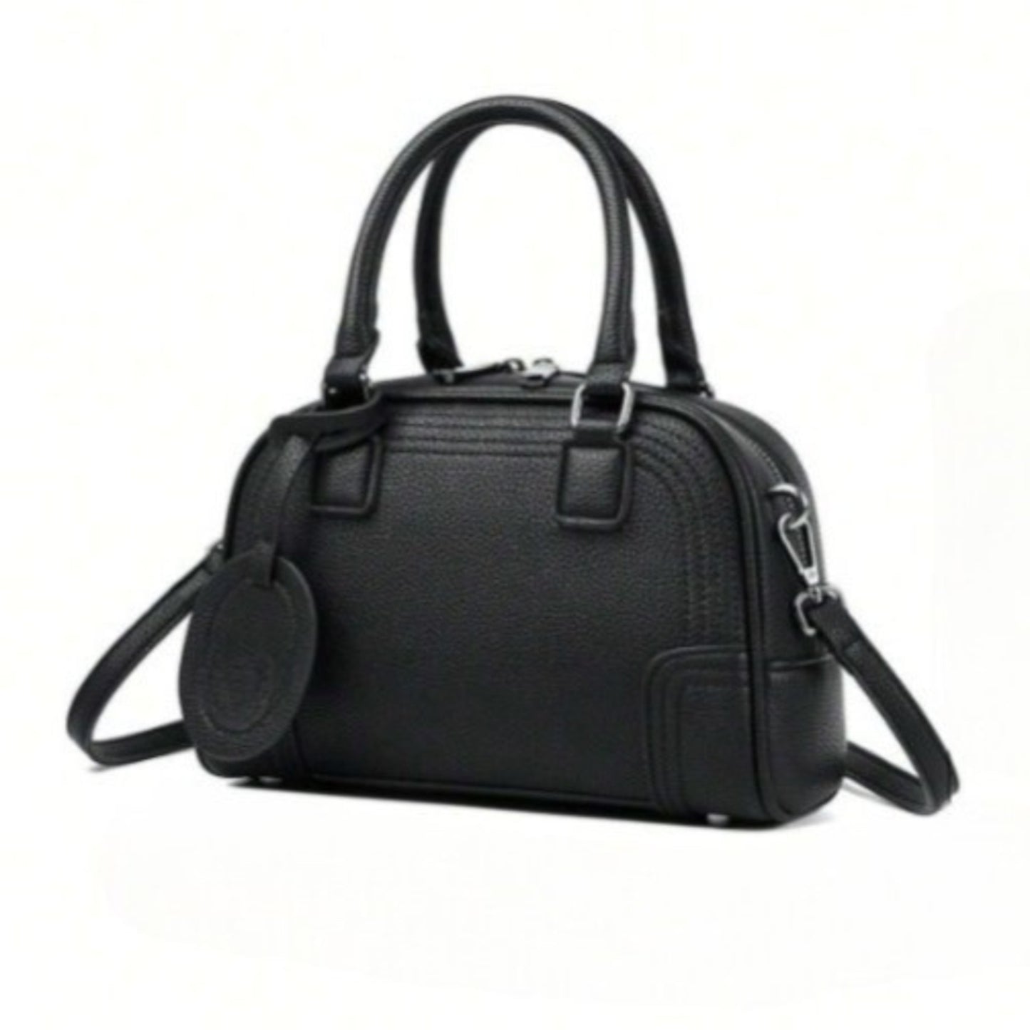 Celeste, a black PU leather handbag with top handles, silver hardware, and a detachable, adjustable crossbody strap attached.