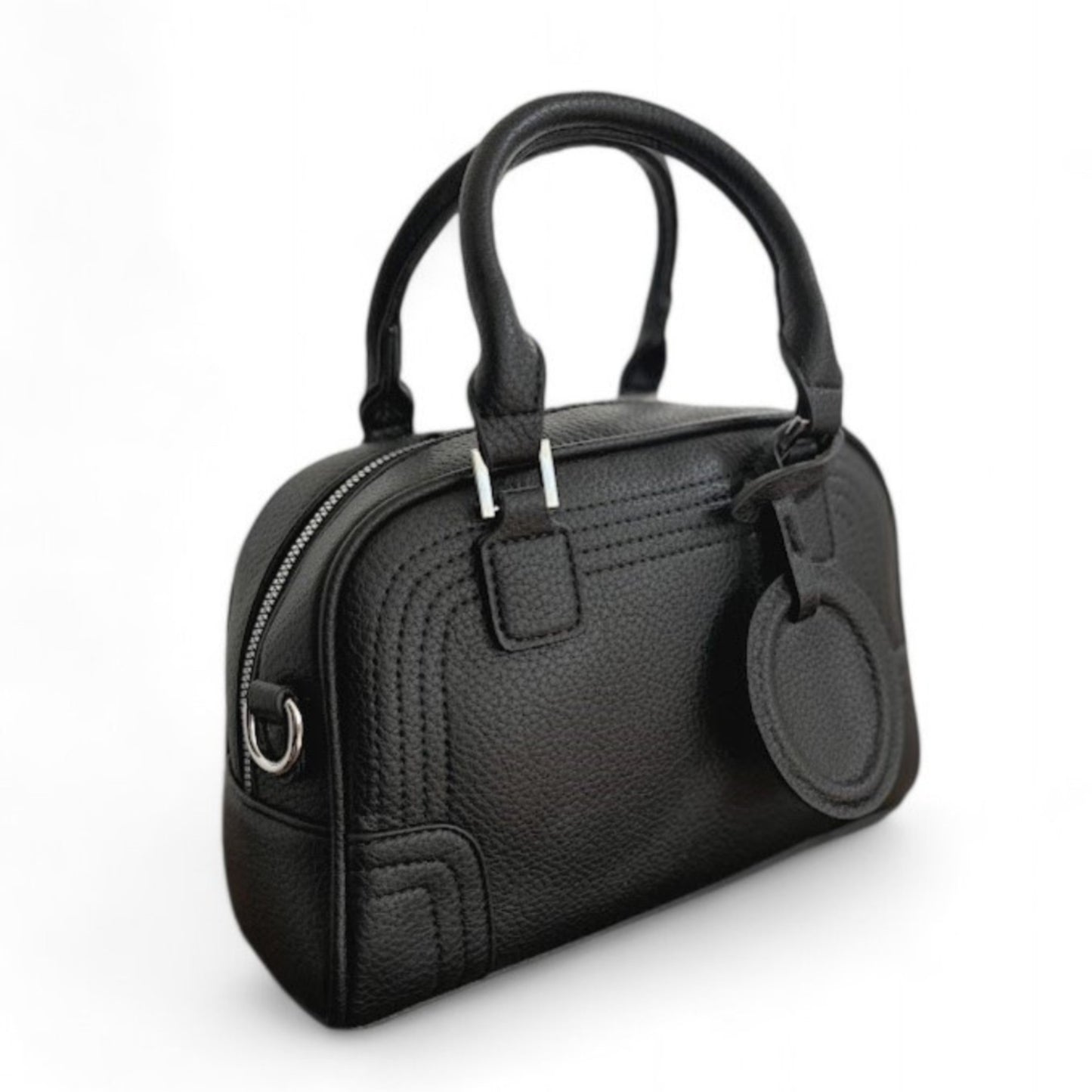 Close-up of Celeste, a black PU leather bowling bag with double top handles and silver hardware.