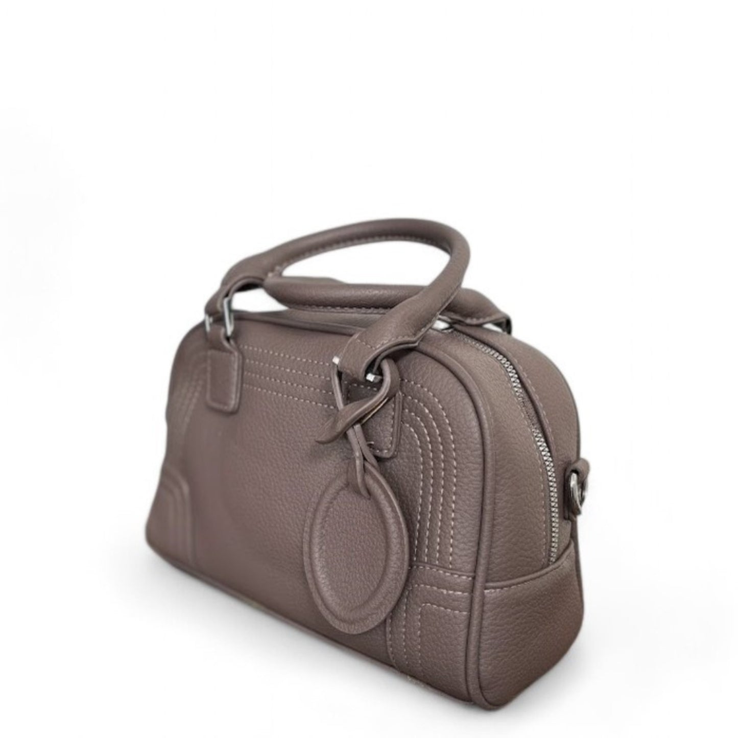 Angle view of Celeste, a taupe PU leather bowling bag with double top handles, silver hardware & top zip closure.
