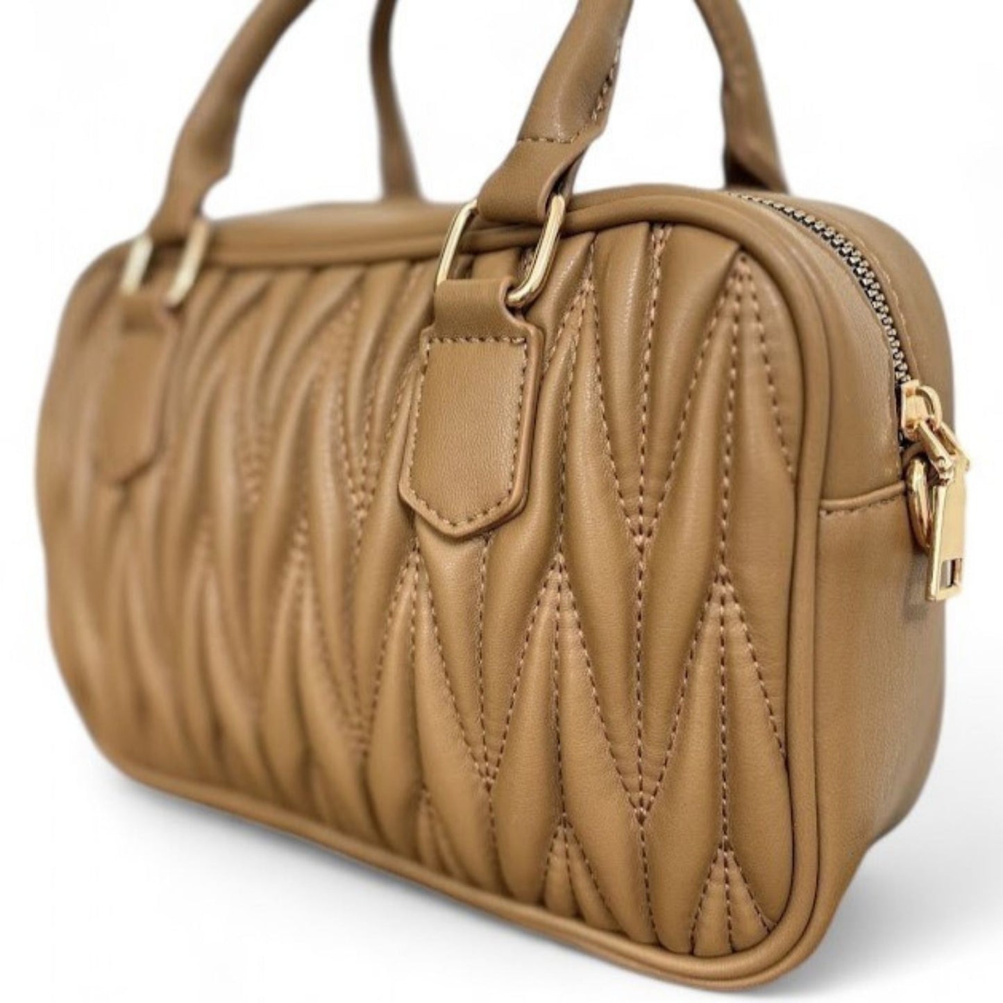 Close-up view of a caramel bag with quilted pattern, gold-tone hardware, and top handles.