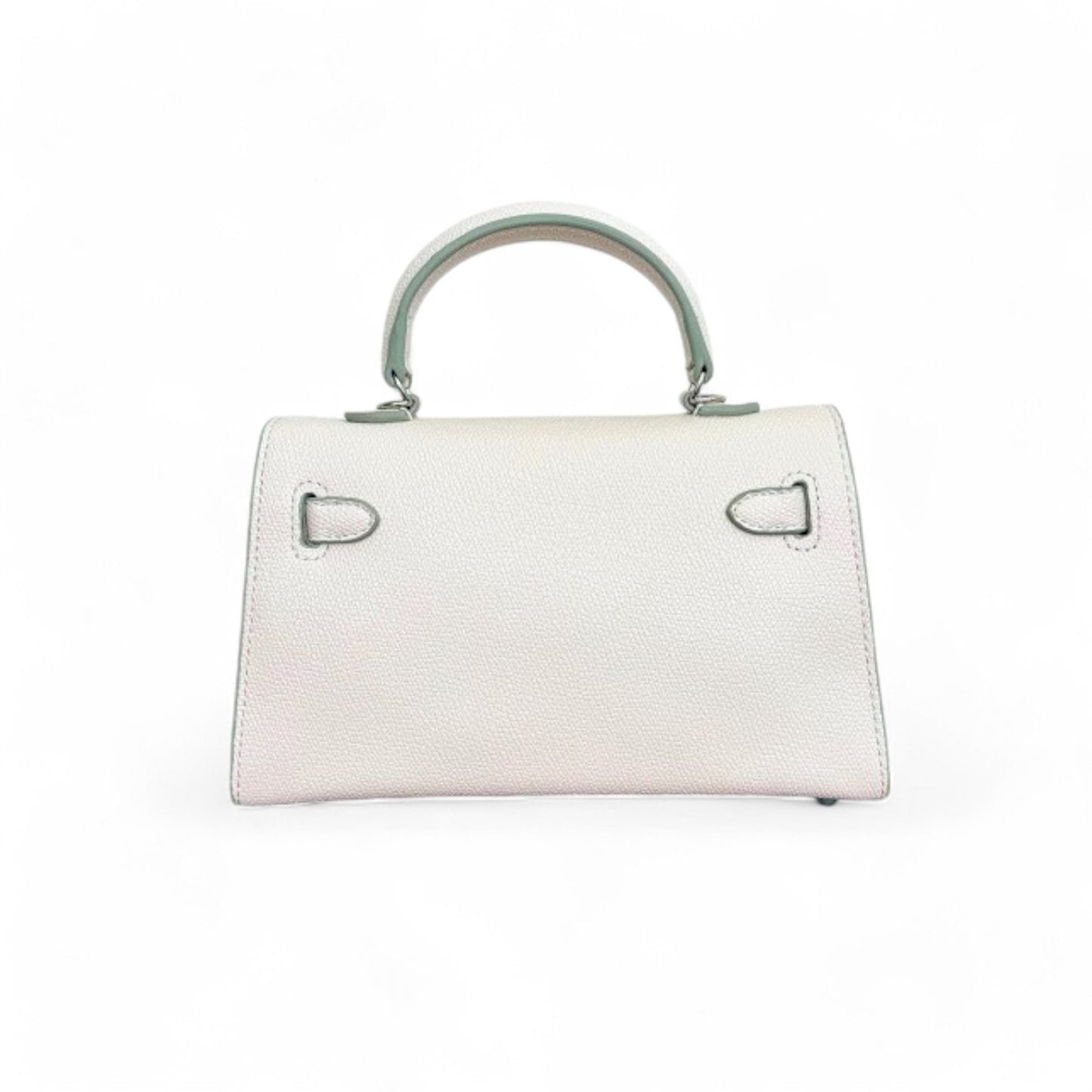 Back view of a white structured trapezoid shape mini top-handle bag.