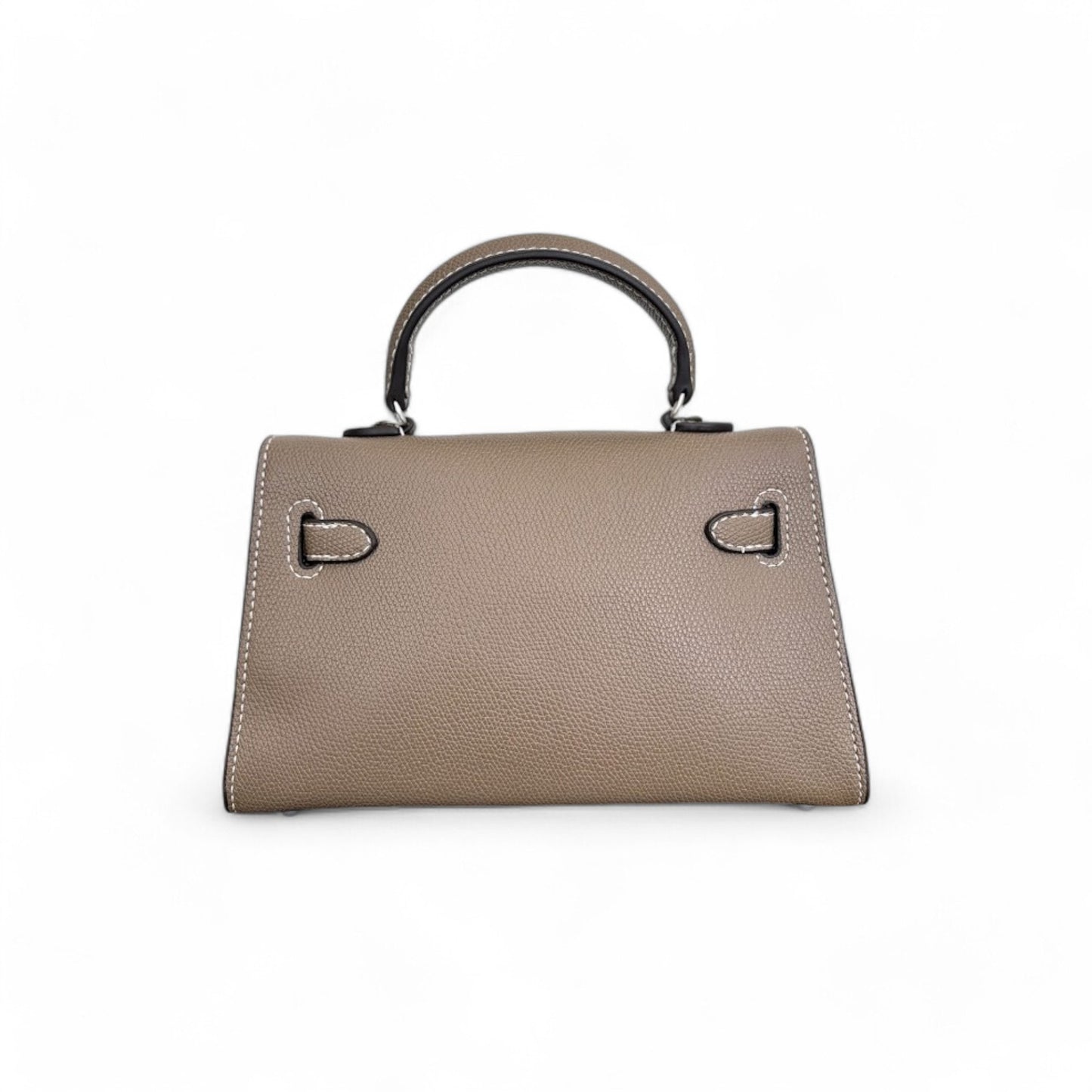 Back view of a taupe structured trapezoid shape mini top-handle bag.