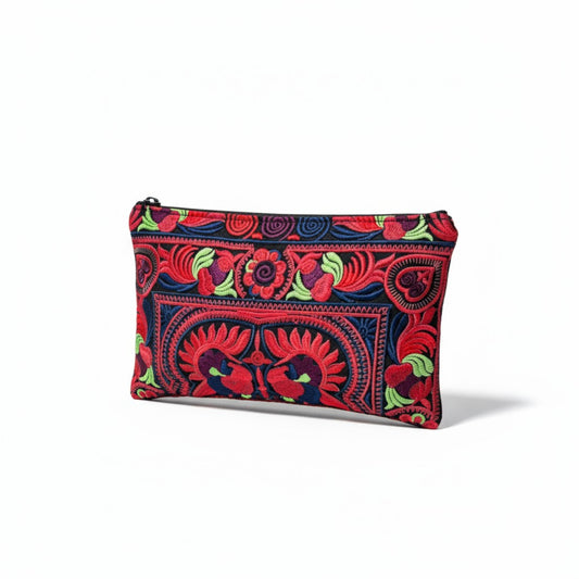 Angle view of an embroidered case pouch with vibrant red, green and blue flower and bird patterns.