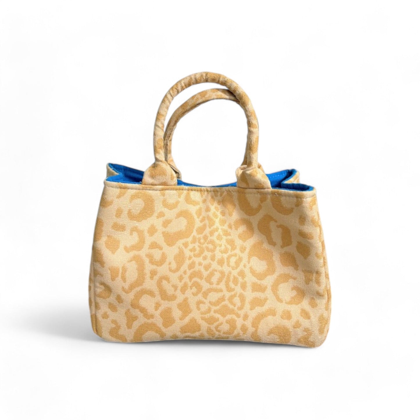 Front view of a handmade yellow leopard-print mini tote bag with top handles and bright blue lining.