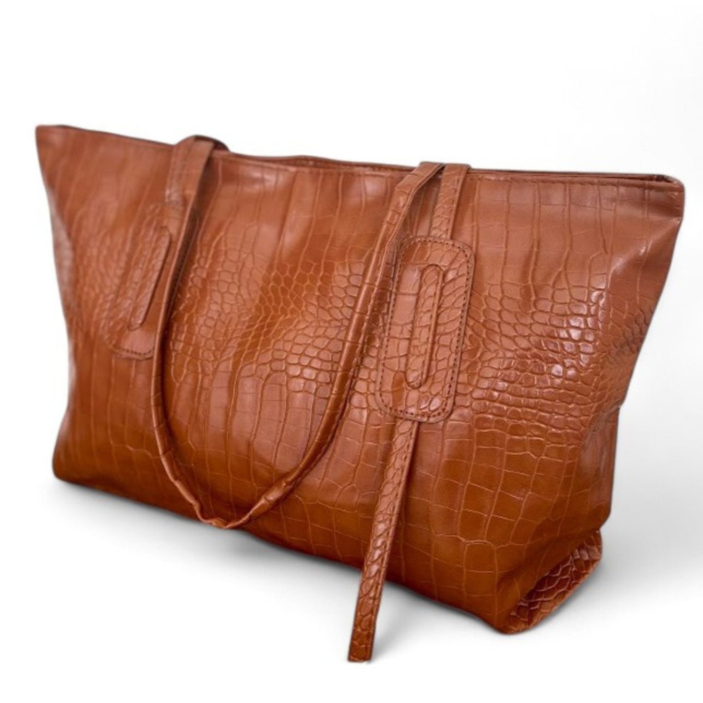 Angle view of brown croc-textured tote bag with shoulder straps and minimalist design.