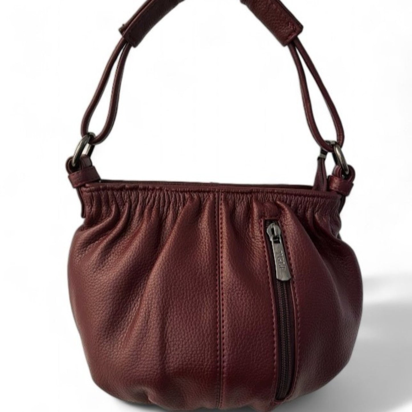 Close-up view of a maroon pleated bucket bag featuring a vertical front zip pocket and a top handle.