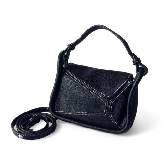 Black geometric handbag with contrast stitching, top handle and detachable long strap.