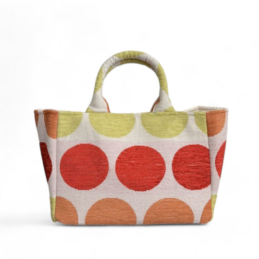 Mini tote featuring red, green, and orange dots on beige fabric, with expanded side panels.
