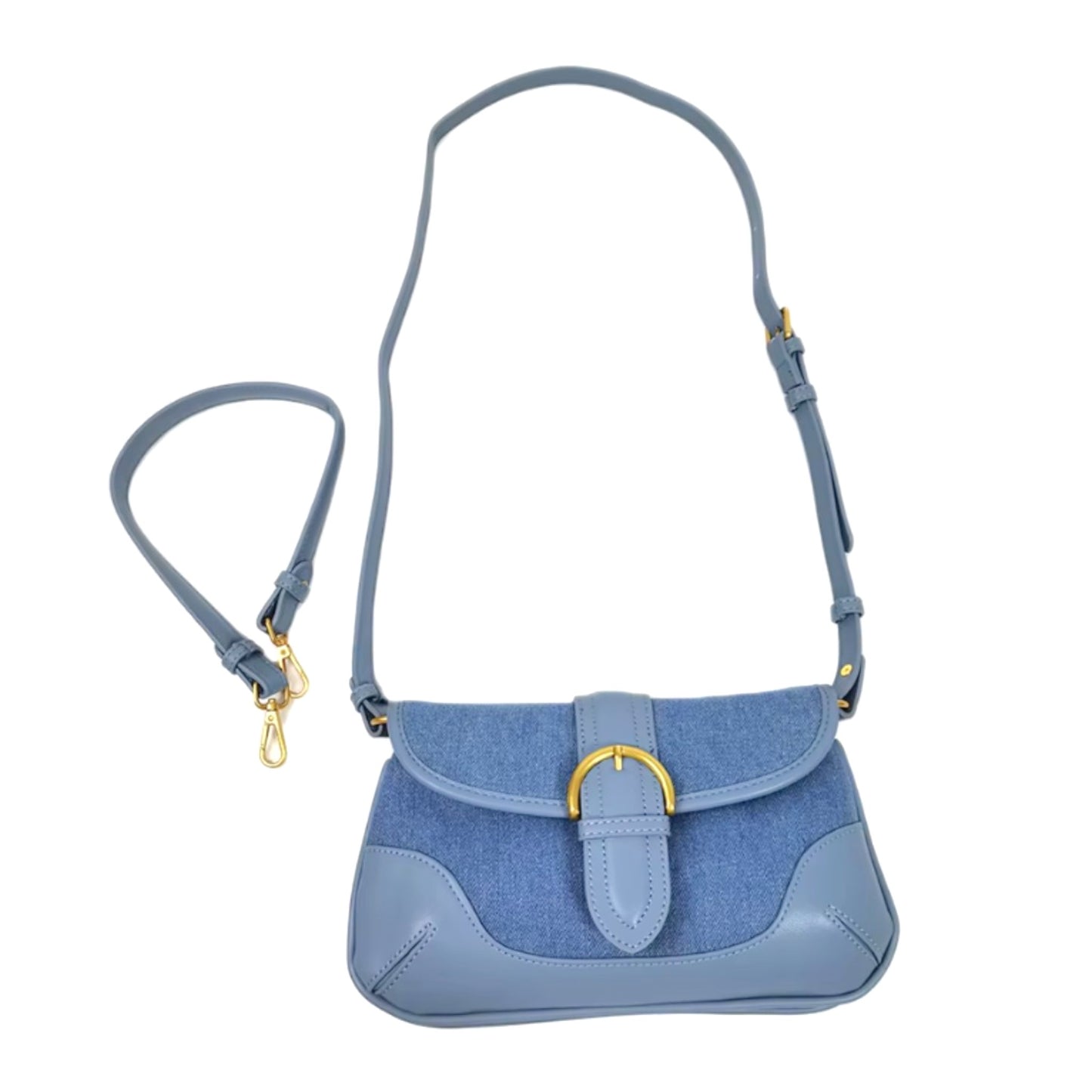 A flat lay of a blue denim bag showcases its long and short straps, along with leather trim and brass-tone details.