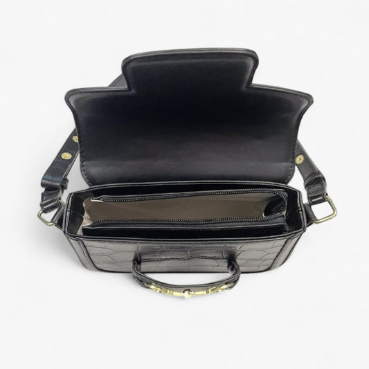 Top view of a black handbag with an opened top flap showing a zip closure.