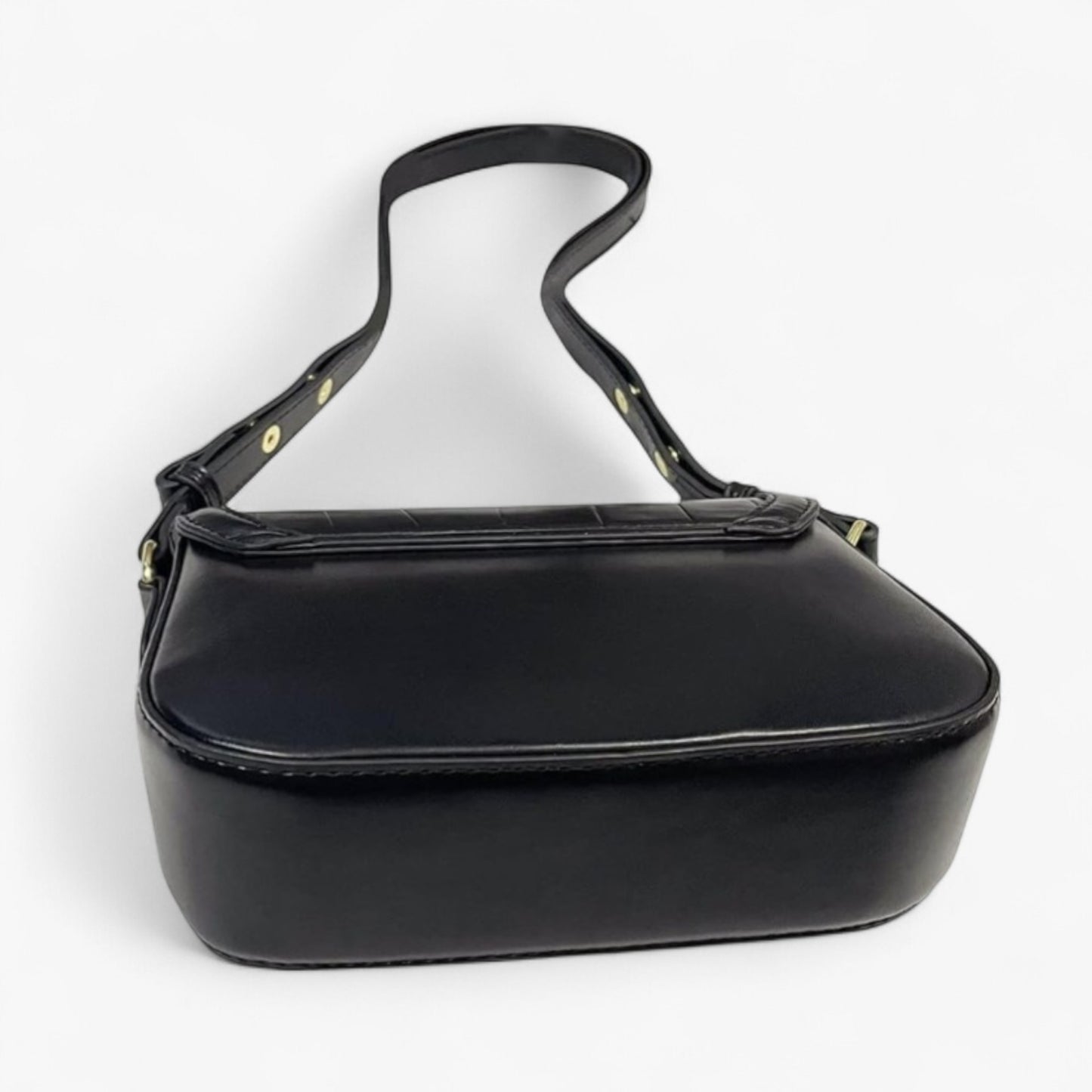 Rear view of a black handbag with gold accents, featuring a smooth back and base panel.
