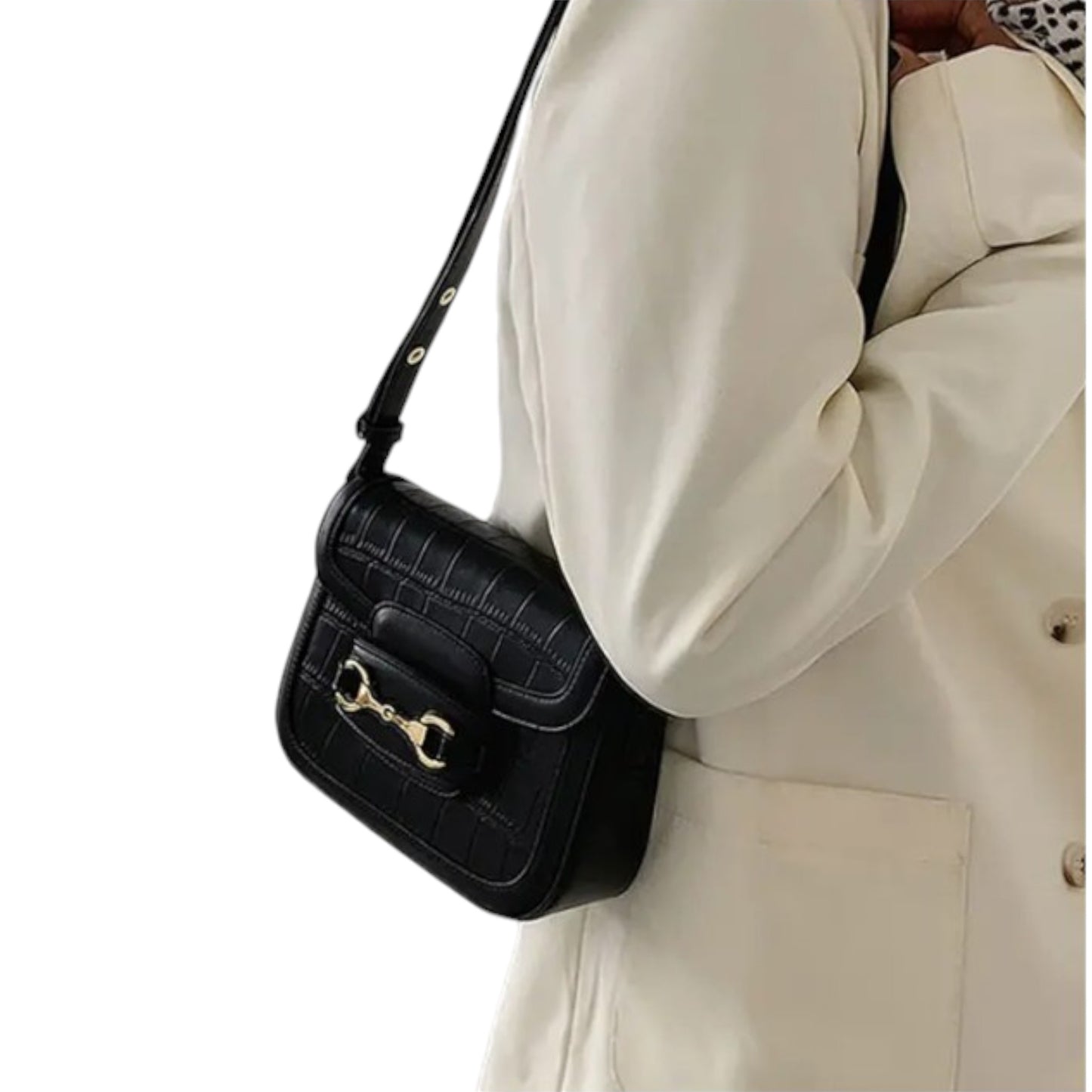 A person carries a black crocodile-embossed bag with gold horsebit over the shoulder.