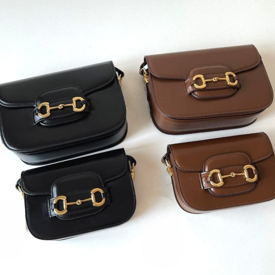A black and a brown medium leather bag, and a black and a brown small leather bag, lying side by side.