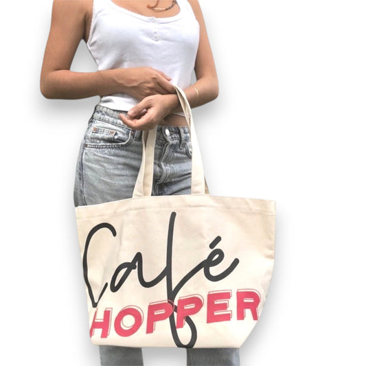 Oversized Café Hopper tote modeled for everyday use, chic and versatile street style bag.