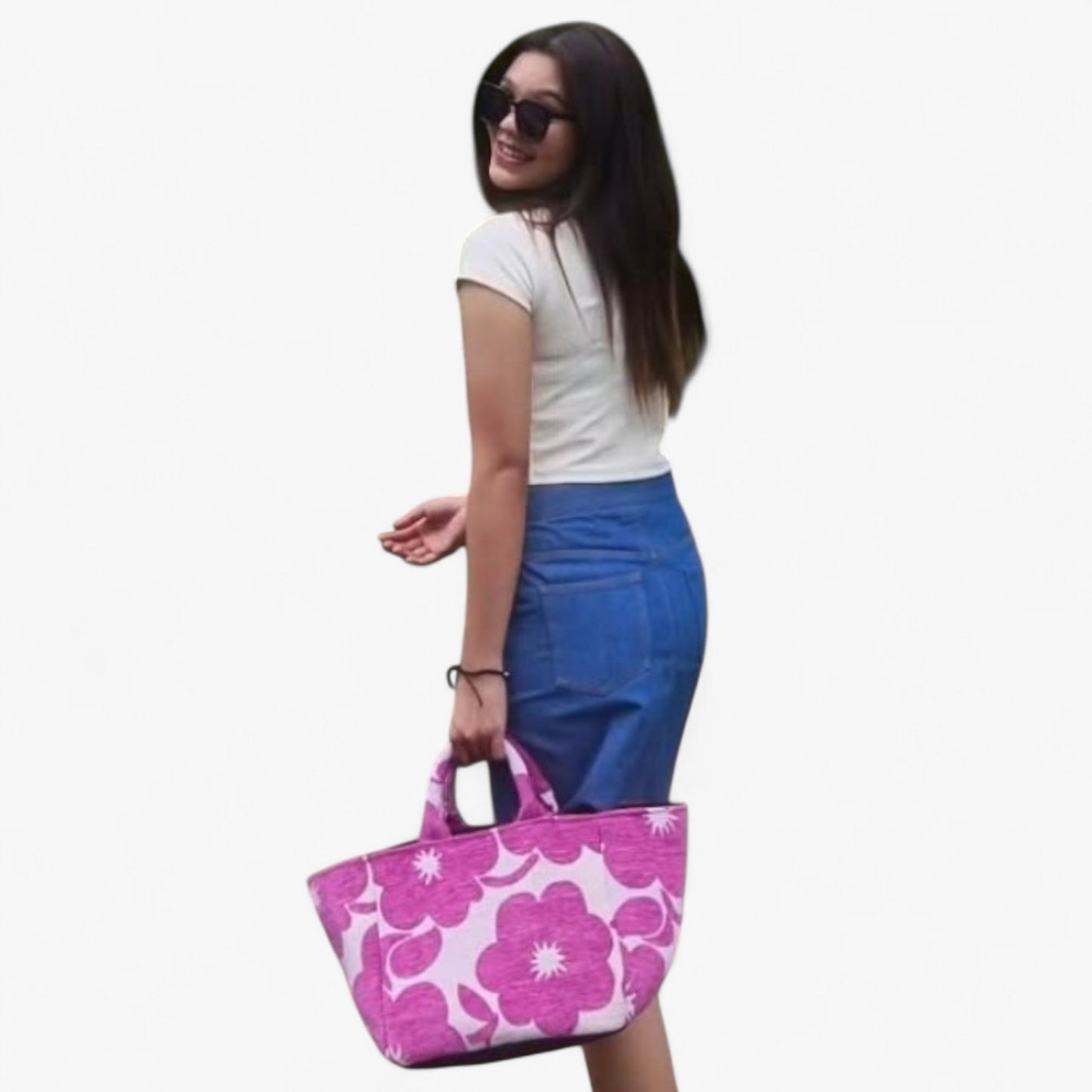 A woman is seen from behind, holding a magenta floral shopper bag that highlights its size and style.