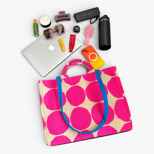 Pink polka dot tote bag with handles and a blue strap. Practical size for work and weekend use.
