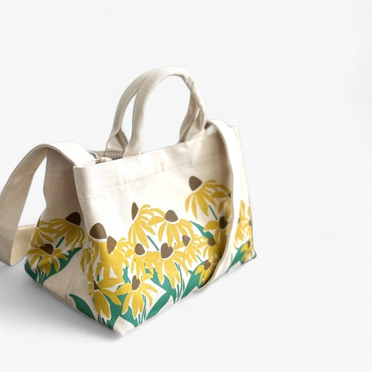 Stylish sunflower print canvas tote bag with durable with a shoulder strap and dual handles.