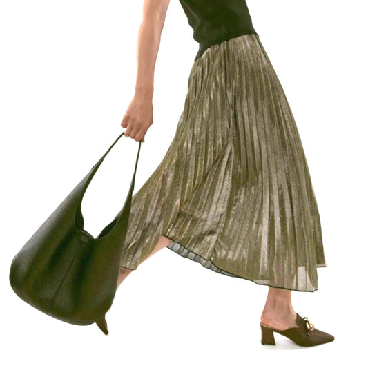 A woman is walking and holding a strap of a black hobo bag.