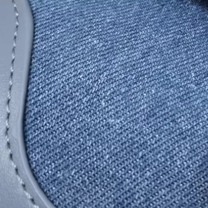 Close-up of blue denim fabric with stitching detail. Ideal for casual everyday style.