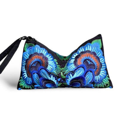 Front view of an embroidered clutch bag with bold blue and green flowers design.