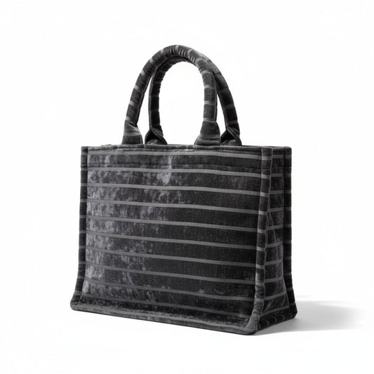 Front angle view of handmade black chenille Book Tote with striped detail and padded handles.