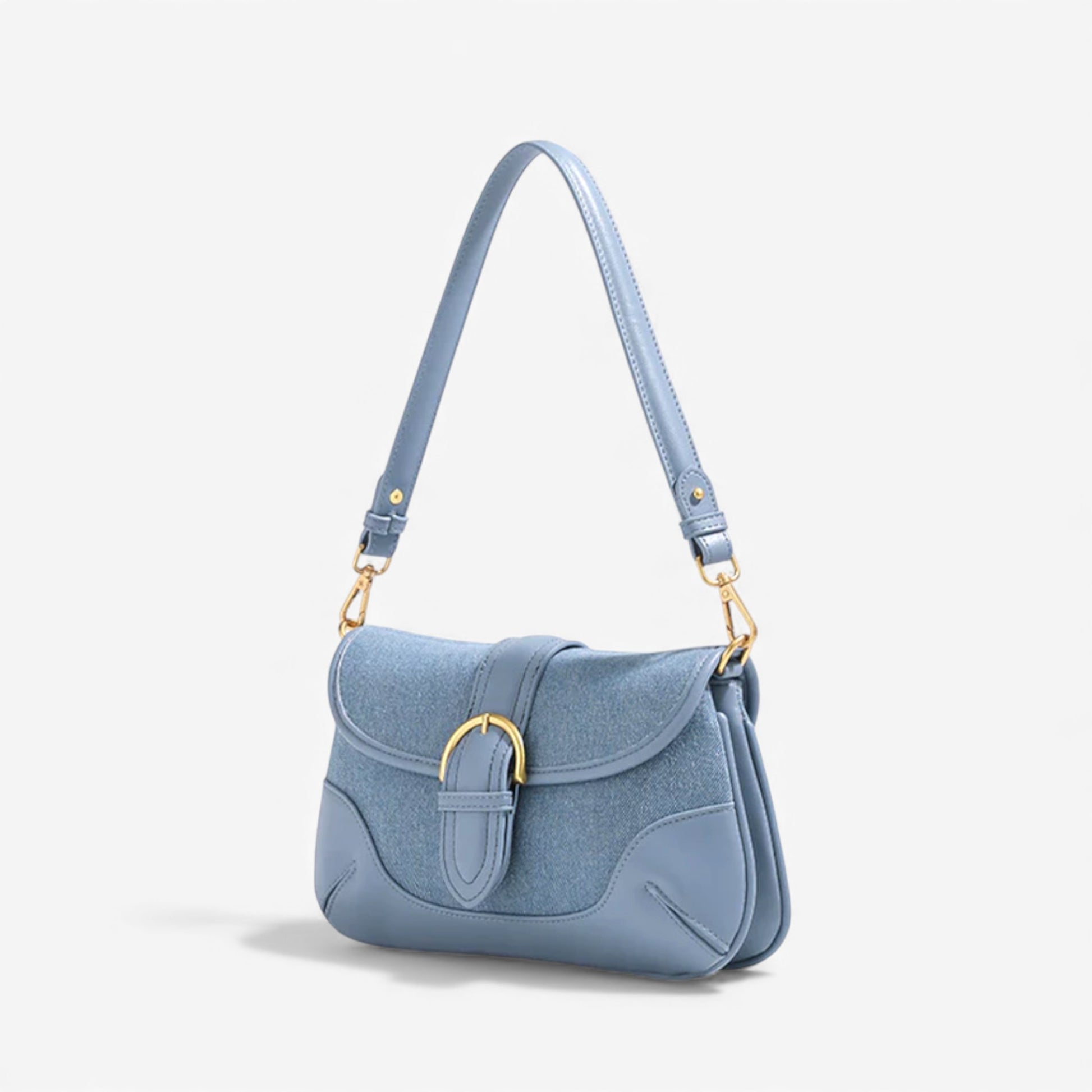 Angle view of a blue denim shoulder bag with gold hardware fashion chic.