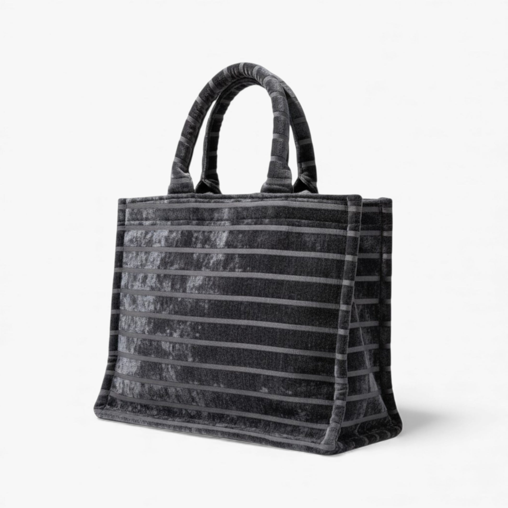 Angled view of a black tote bag with horizontal textured stripes and structured shape for everyday use.