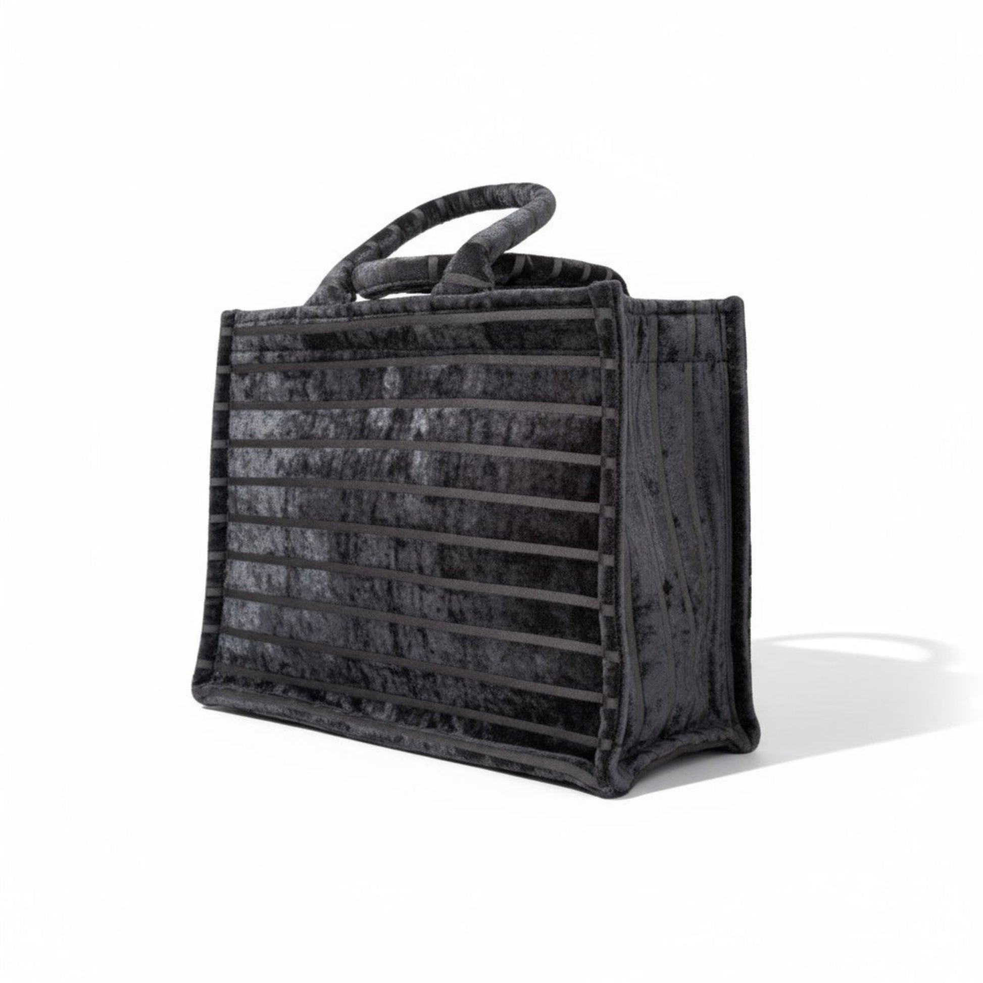 Side view of Black Chenille tote bag showcasing its striped velvet texture and durable construction. 