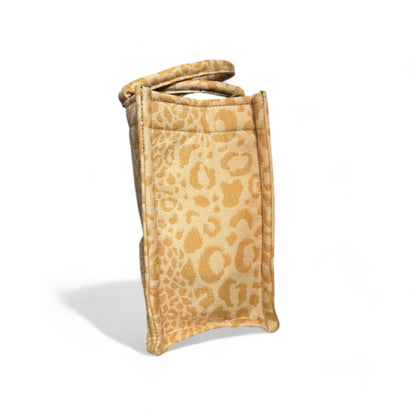 Side view of a yellow leopard print tote bag displaying its structured shape and reinforced seams.