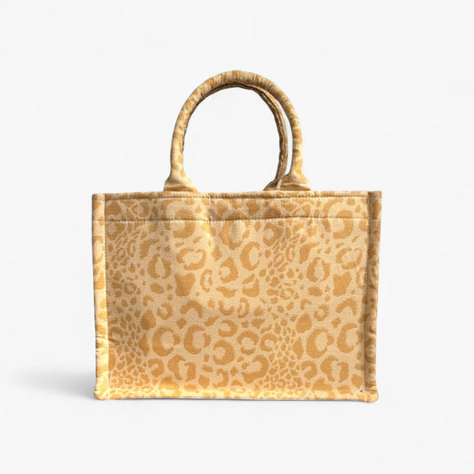 Front view of a yellow leopard handmade book tote with soft double handles and a structured design.