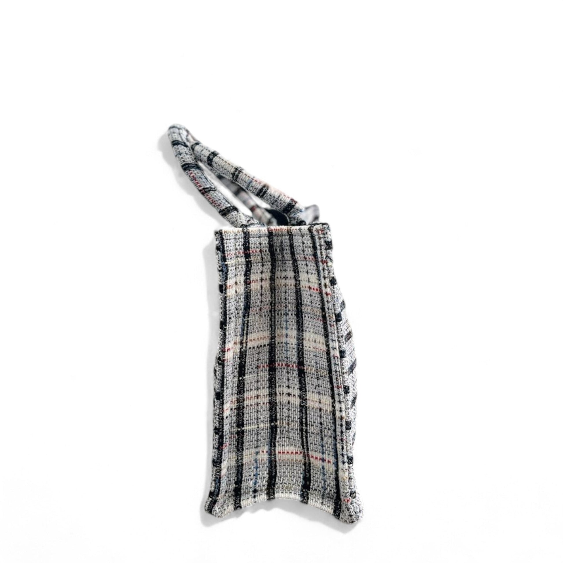 A Classic plaid-patterned white tweed book tote in side view.