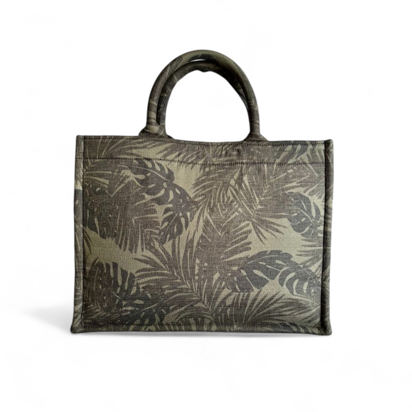  Front view of a book tote featuring black and green monstera and palm leaf patterns.