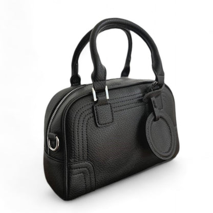 Close-up of Celeste, a black PU leather bowling bag with double top handles and silver hardware.