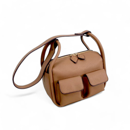 Angel view of brown faux leather Dougie bag with two front flap pockets, top zip closure, and a detachable long shoulder strap.