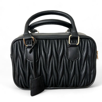 A black handbag with a quilted pattern, featuring gold-tone hardware, double top handles, and a zipper closure.