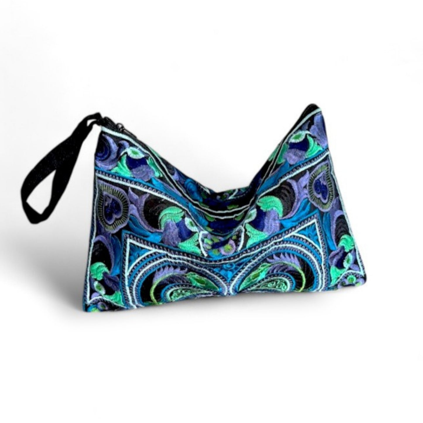 Close-up of an embroidered blue and green bag with a black loop strap.