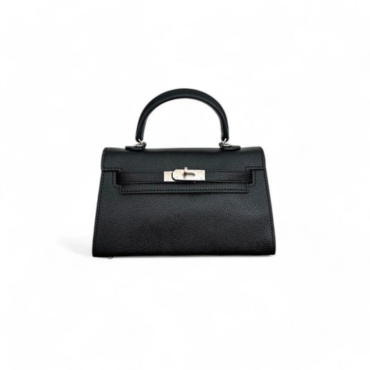Front view of black mini top-handle bag with silver hardware and flap closure.