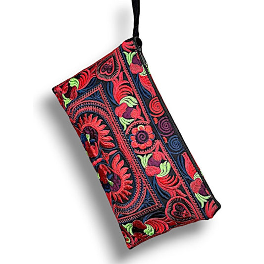 A black clutch with vivid red and green floral and bird embroidery, featuring a wrist strap and a zipper.