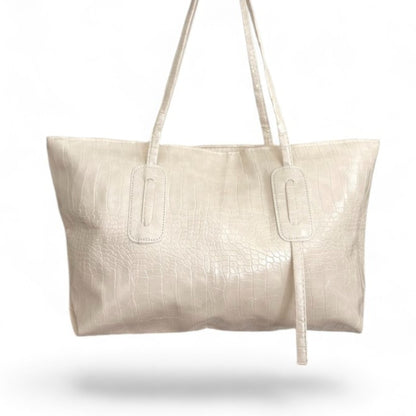 Off-white croc-textured Janine tote bag with double straps hanging from above.