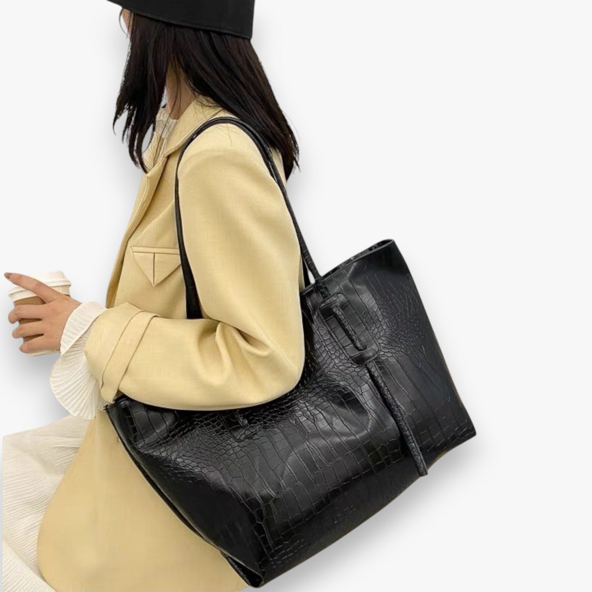 A model carrying a black crocodile-patterned  PU leather chic office tote bag on the shoulder.