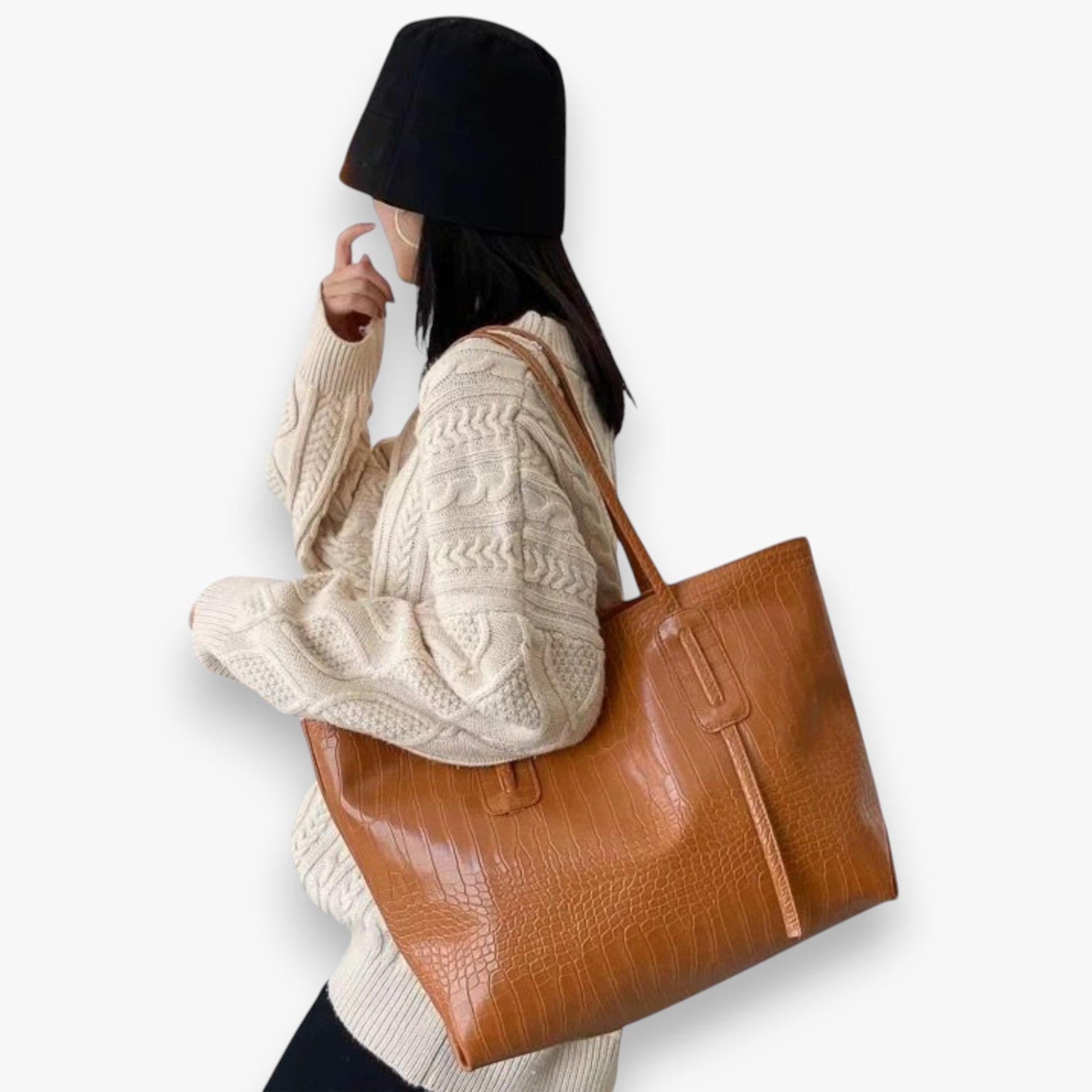 A model carrying a brown crocodile-embossed spacious everyday tote bag on the shoulder.