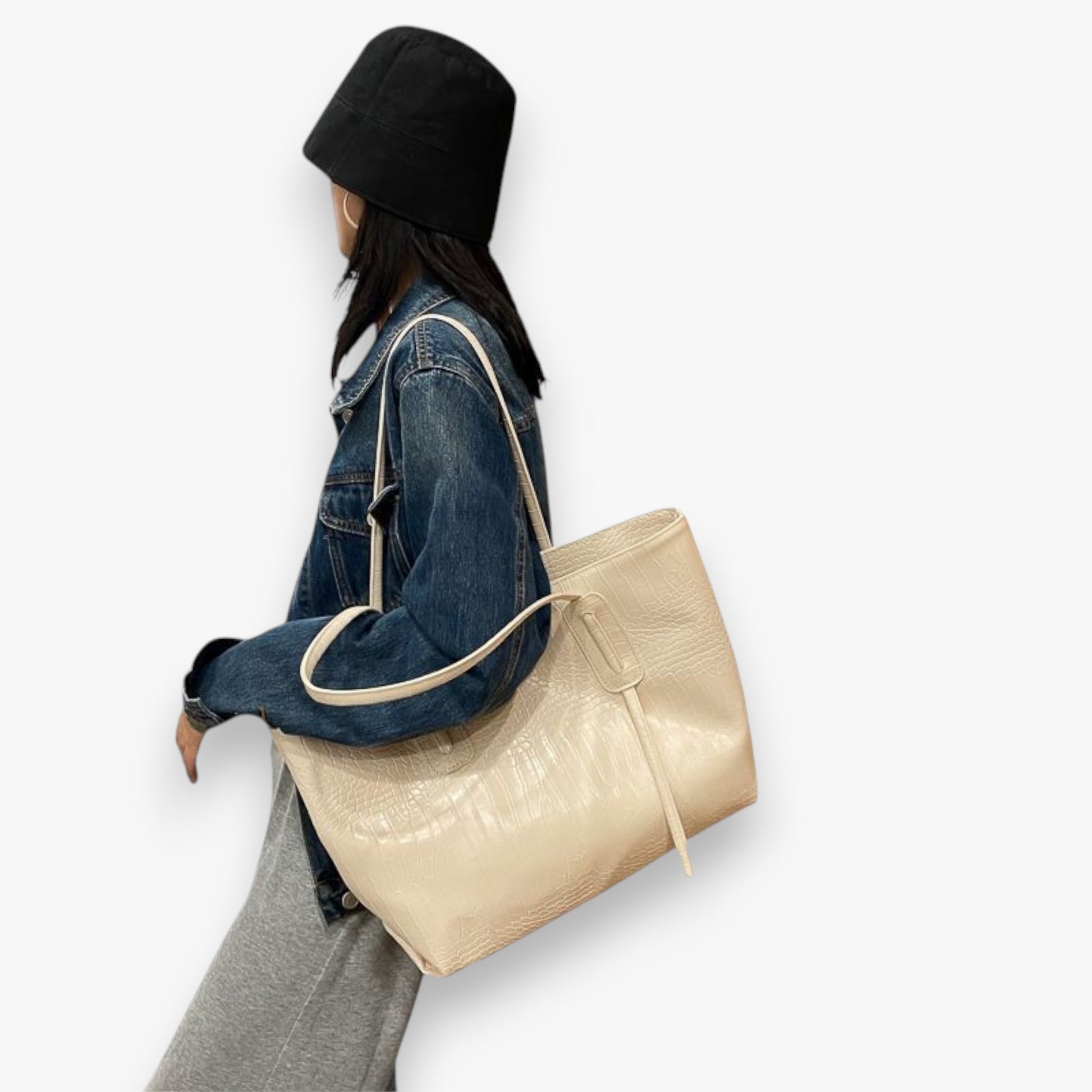 A model carrying a white croc-patterned everyday stylish and practical work tote bag on her shoulder.