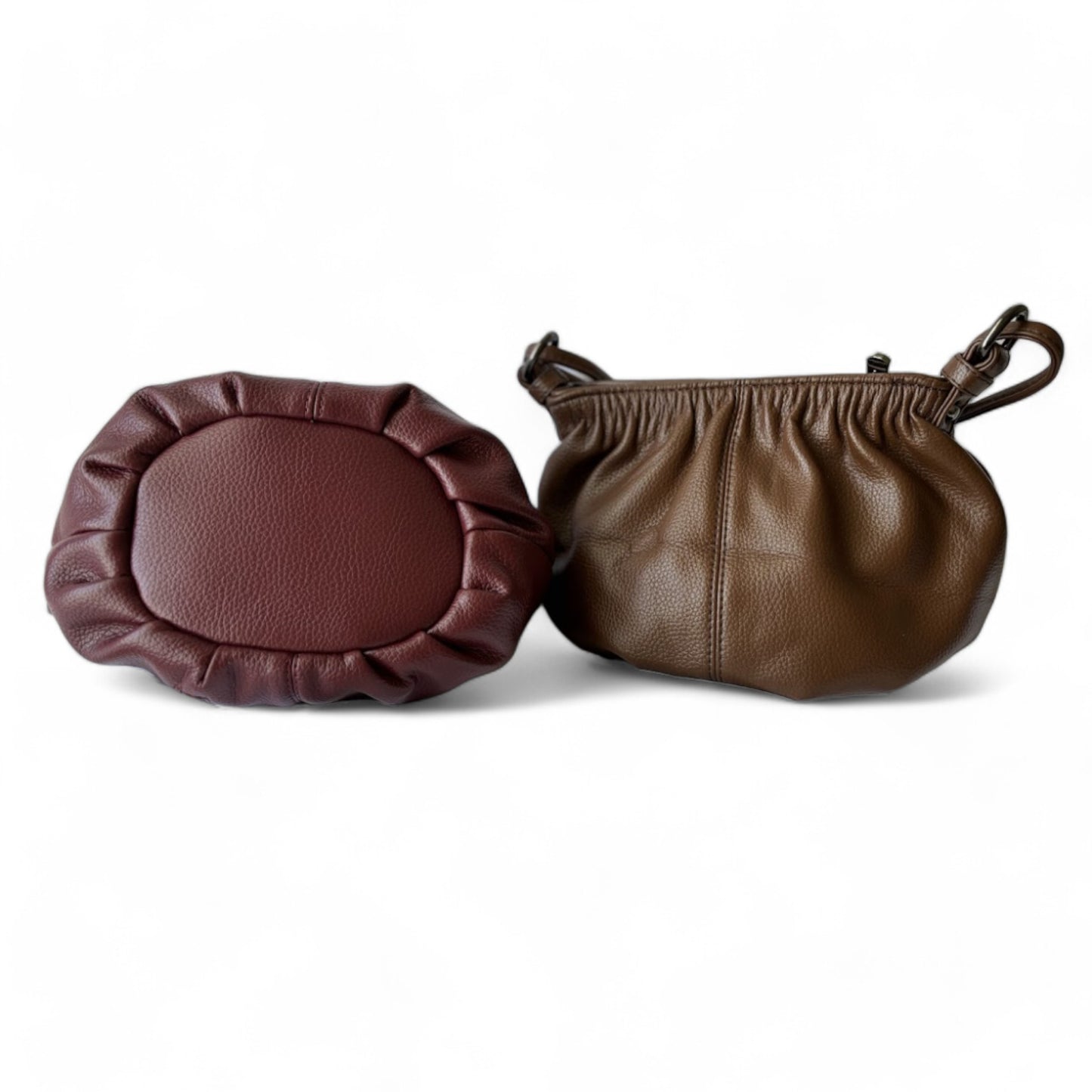 Bottom view of a maroon bag with a round shape and pleated detail. Back view of a pleated bucket coffee handbag.