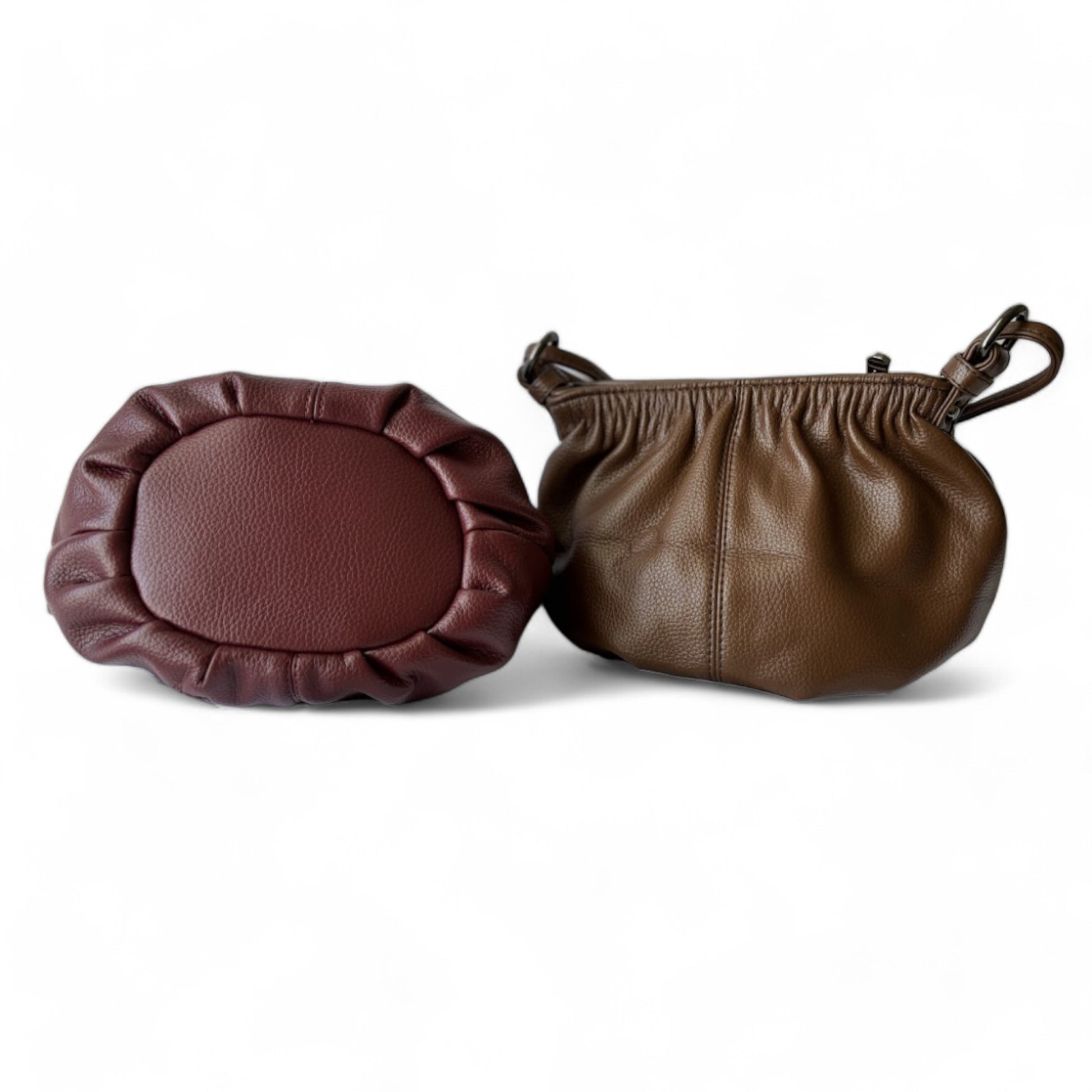 Bottom view of a maroon bag with a round shape and pleated detail. Back view of a pleated bucket coffee handbag.